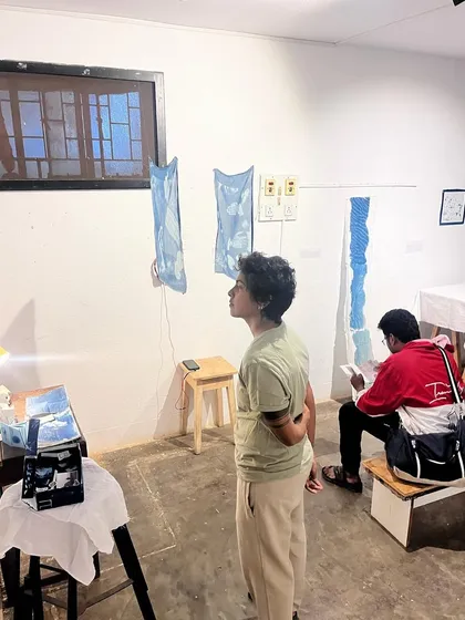 Visitors admiring the final artworks displayed at the end of our weekend photography and cyanotype workshop. The studio transforms into a gallery showcasing the participants' creations.