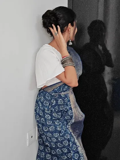 A detailed look at a messy bun hairstyle, perfect for a modern ethnic look. This style adds texture and volume while keeping the hair neatly tied up.