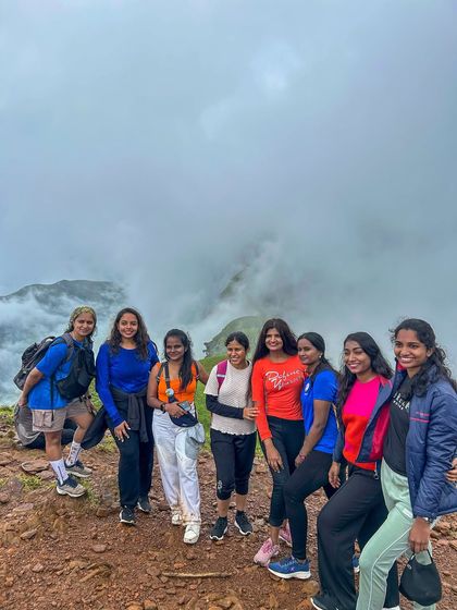 A group of friends posing together on the misty trail of Netravathi.