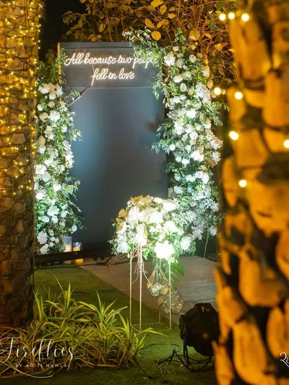 "All because two people fell in love." A neon sign with this sweet message was nestled within a floral arch, creating a perfect, heartfelt photo opportunity.