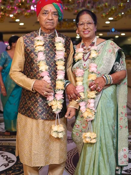A full length portrait of the couple in their traditional attire for their golden jubilee anniversary party.