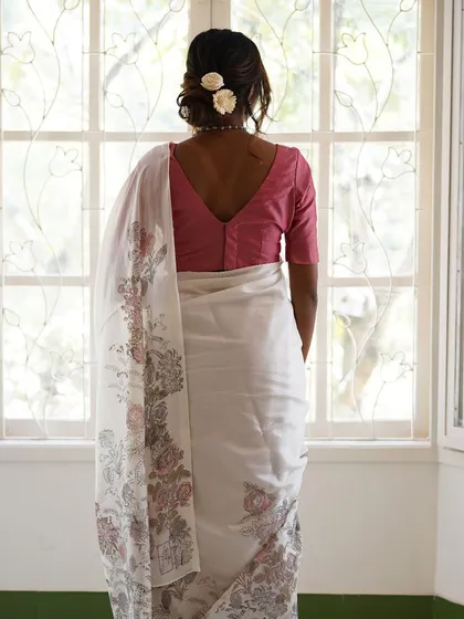 The Mallika saree is a breath of fresh air, crafted in custom linen with a woven border. Its design features a joyful bouquet of vintage jacaranda, rose, and petal block prints, accented with delicate hand-embroidered details for a light, breezy feel.