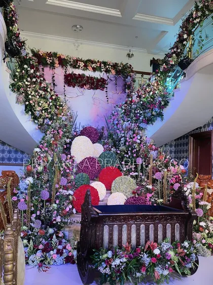 This lavish floral setup for a cradle ceremony was a dream to design. We filled the space with beautiful blooms in jewel tones, creating a magical garden to welcome the newest member of the family.