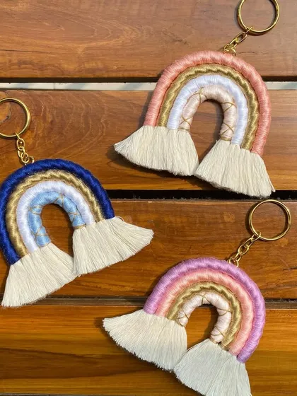 Three of our custom macrame rainbow keychains displayed together. Each one is handcrafted with carefully chosen colors to create a beautiful, unique accessory for your keys or bag.