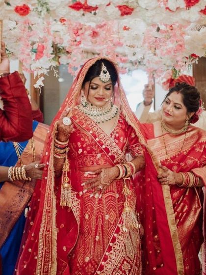 The bridal entry. All eyes are on our stunning bride as she makes her way to the mandap, looking absolutely breathtaking in her red lehenga.