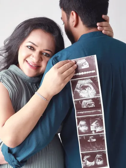 Sharing a secret with the world. This playful pose with the ultrasound strip is a creative way to announce your pregnancy and celebrate this special milestone together.