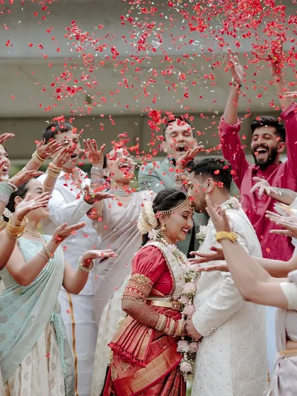 A moment of pure celebration as friends and family shower the newly married couple with flower petals. It's these unscripted, high-energy moments that truly tell the story of your wedding day.