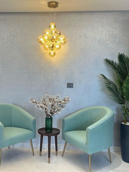 A happy client's waiting area, featuring our cluster globe pendant. The amber glass adds a warm, welcoming glow to the room.