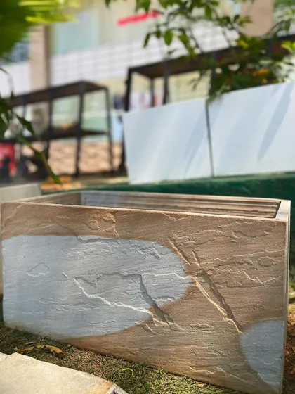 The beauty of natural stone is on full display in this piece from our Stone Series. The two-tone effect and raw, chiseled texture make each rectangular planter a one-of-a-kind work of art.