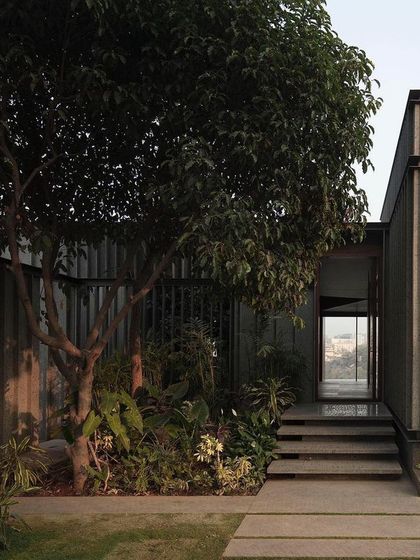 (Duplicate of 54) The approach to the Lakehouse is a carefully choreographed experience, with landscaped pathways leading to a modest entrance that gives way to dramatic interior views.