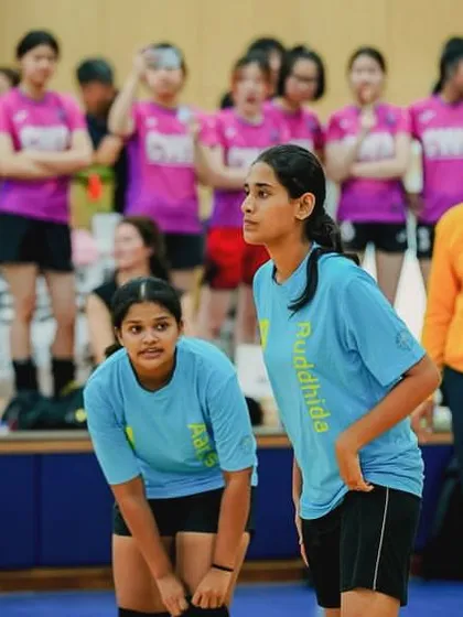 Players on the court watch intently, ready to react. Every member of the team, whether playing or on the bench, is fully engaged.