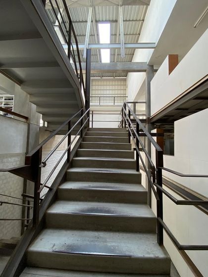 Looking up the main staircase at Zanav Home. The combination of heavy concrete treads and a light steel structure is a hallmark of our approach.