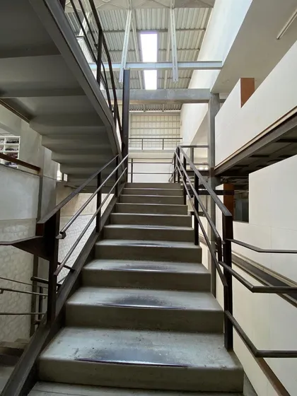 Looking up the main staircase at Zanav Home. The combination of heavy concrete treads and a light steel structure is a hallmark of our approach.