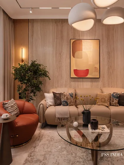 A living room designed for connection and conversation. I used sculptural forms, like the curved leather armchair and unique coffee table, to add personality. The warm wood walls and layered textiles ensure the modern aesthetic still feels cozy and inviting.