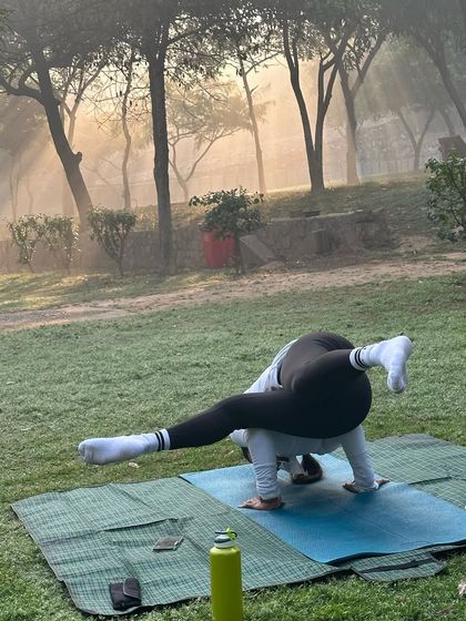 Finding balance and strength in an arm balance during a foggy morning class.