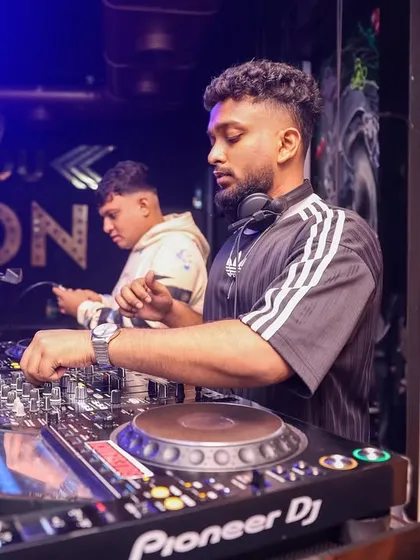 Working the controls at a busy club. Every knob and fader is used to shape the sound and build the energy on the dance floor.
