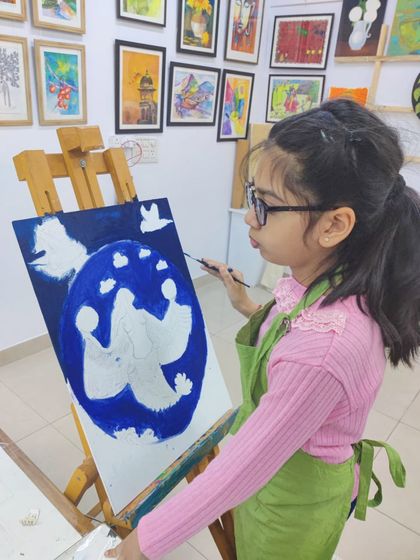 A series showing different students working on and completing a large, imaginative mermaid painting.