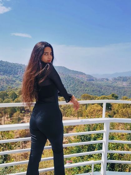 Another shot from our mountain photoshoot. The sheer top adds a touch of texture to the all-black ensemble, proving that details matter when creating a memorable travel look.