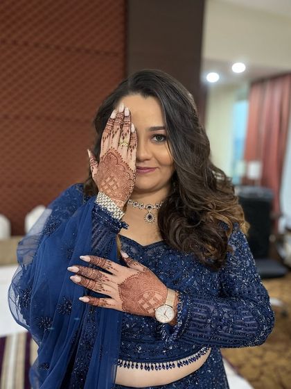 A glam look for a Sangeet and Engagement party. The bride is wearing a stunning royal blue lehenga, and her makeup is bold and beautiful to match.