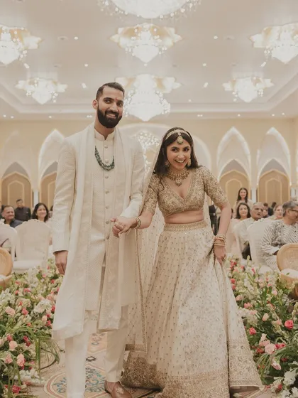 Walking down the aisle as husband and wife. Her joy is palpable, and her makeup looks flawless.