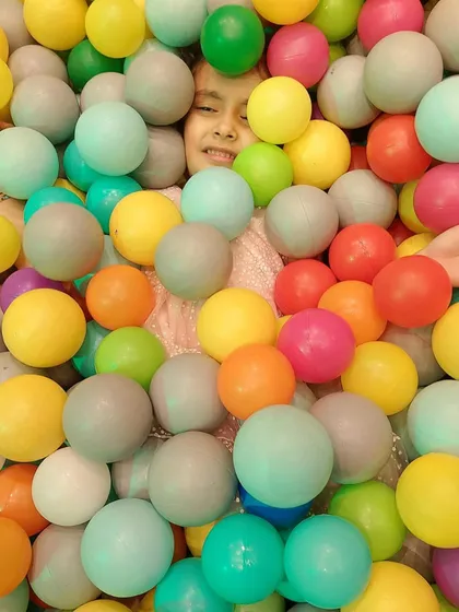 Just peeking out! Getting buried in the ball pit is all part of the fun.