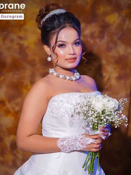 A full view of the Christian bridal look, complete with a white gown and bouquet. My courses prepare students for a global market, including Western bridal styles.