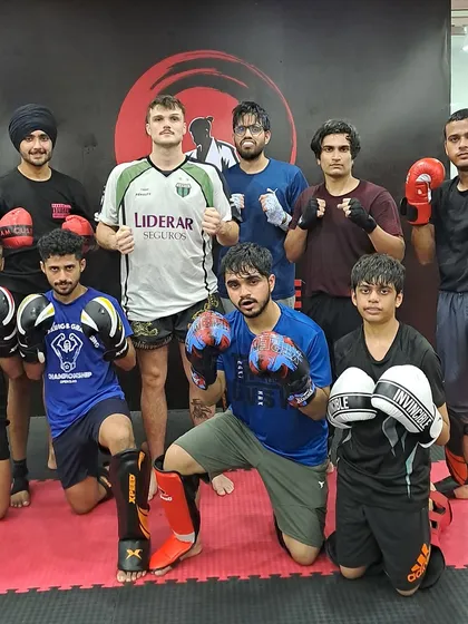 The Muay Thai crew after a session with their coach, showcasing the results of hard work and dedication.
