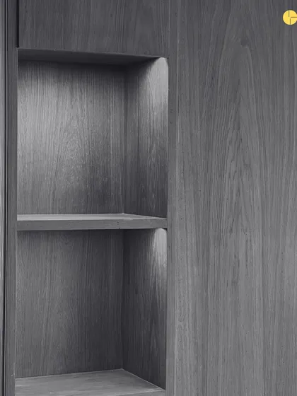 A close-up of a built-in shelf, showcasing the beautiful grain of the wood veneer. This is an example of the quiet, obsessive detailing that goes into every project.