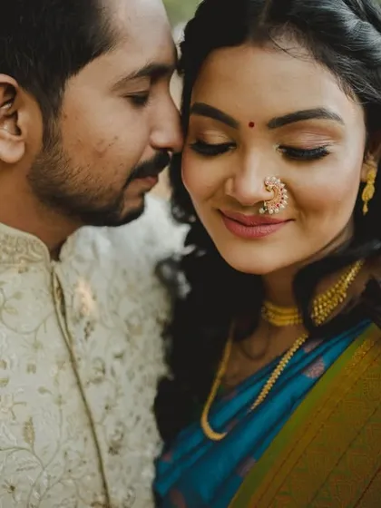 A tender moment captured up close. The groom whispers to his bride, whose traditional nath and serene expression are the focus. These are the quiet, intimate portraits that tell the real story of a couple's bond.