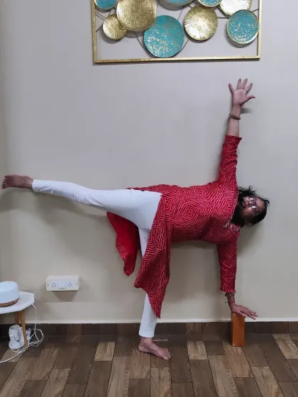 Age is truly just a number. Here is one of my students, over 60 years old, gracefully holding Ardha Chandrasana (Half Moon Pose) with block support. My classes for seniors are designed to build strength and improve mobility safely.
