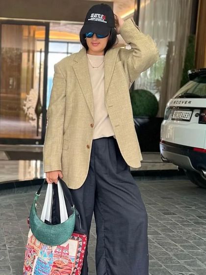 The Selena Forest Green styled for travel. Its compact size and striking color make it a practical yet fashionable choice for any journey.