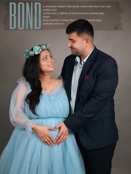 Titled 'Bond', this image captures the deep connection between the expecting parents. They share a loving look as they both hold the baby bump, her in a beautiful blue gown and floral crown.
