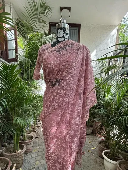 The full view of the powder pink saree, showing its graceful and flowing silhouette. It’s a perfect outfit for a sundowner or a day wedding.