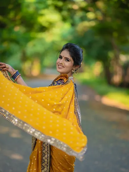 A playful and dynamic shot of the saree-lehenga. The flowing fabric and the model's happy expression capture the fun and versatility of this unique draping style.