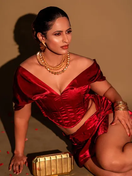 A different angle of the red velvet co-ord set, showing the versatility of a single outfit and setup. The lighting creates a warm, inviting glow on the skin.