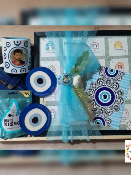 Another take on our popular Evil Eye theme. This hamper includes a handmade vision board, custom coasters, a personalized mug, and a sunglasses case.