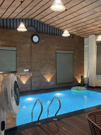This indoor swimming pool demonstrates our approach to creating inviting recreational spaces, even within compact volumes. The design combines rustic stone walls, warm wood decking, and focused lighting to craft a private, resort-like atmosphere.