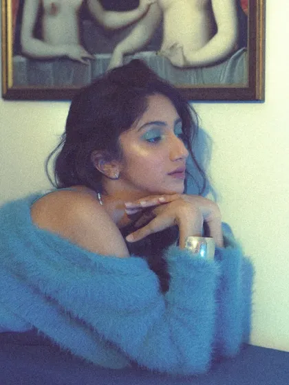 A blurry, artistic take that emphasizes the mood and color palette. The bright blue eyeshadow becomes the focal point in this expressive, high-fashion shot.