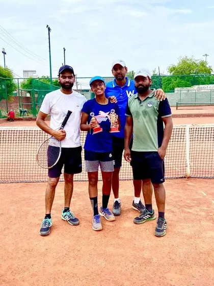 Our coaching team with academy trainee Khushi Sharma, celebrating her runner-up and winner trophies in the CS7 U-16 singles and doubles categories.