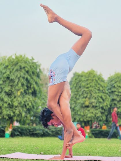 The Brahamastra Asana, performed in the park. This pose is a testament to what the body can achieve with dedicated practice and a strong mind.