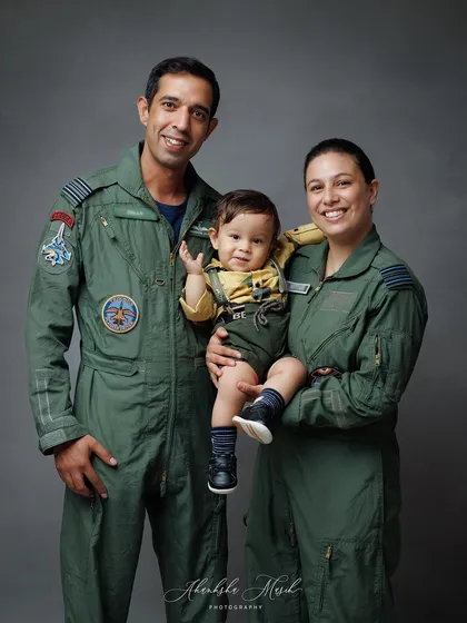 A slightly different pose from the Airforce family session, capturing a sweet, interactive moment and the baby's happy wave.