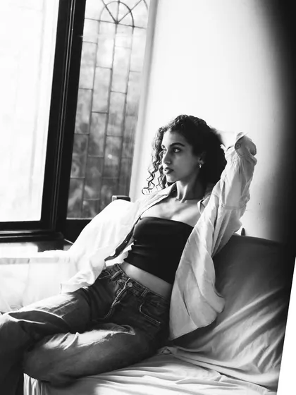 A thoughtful, looking-away pose in black and white. The light from the window beautifully highlights her profile.