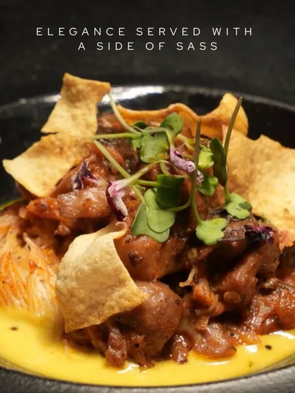 Elegance served with a side of sass. This dish features tender meat in a creamy yellow curry, topped with crispy wonton strips for a delightful textural contrast.