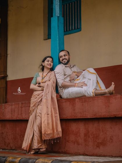 A relaxed and candid moment, leaning against a colorful wall. This showcases their easy-going personalities.