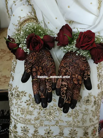 A close-up of the bride's hands with floral bracelets, showcasing the beautiful simplicity of the palm design.