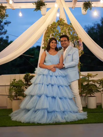 A classic portrait of the expecting couple at our studio. The multi-layered skirt of the 'Charm' gown creates a stunning, full silhouette.