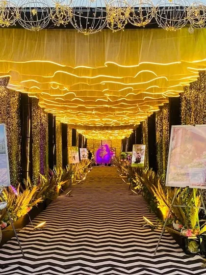 The entrance to the glamorous walkway, framed by golden wire-frame spheres and sequin walls that sparkle in the light.