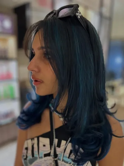 A cool and edgy look with this deep blue color. The layered cut adds texture and movement, making the creative color even more dynamic.