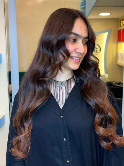 The soft waves bring out the deep, luxurious tones of this beautiful chocolate brown hair color.