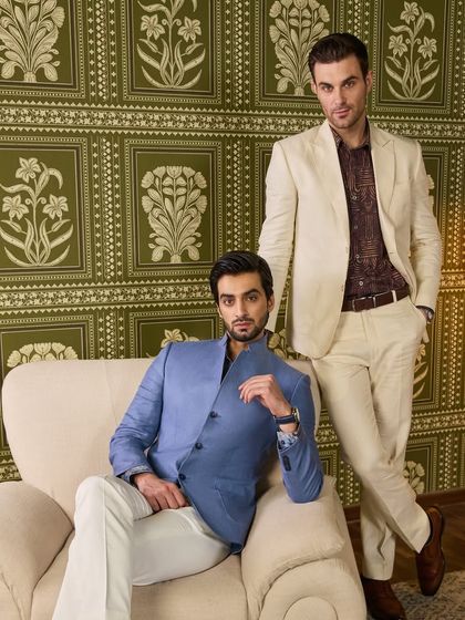 Two distinct summer looks: a sky blue linen bandhgala-style jacket and a classic ivory linen suit. Both are handcrafted to stand out, whether for work or pleasure.